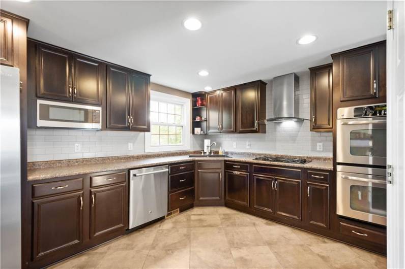 Kitchen Features Neutral Tile Flooring and a Subway Tile Backsplash