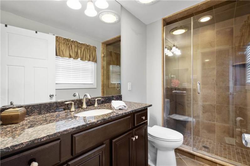 Primary Bath with Granite Topped Vanity and Walk-In Shower with Custom Tile Surround