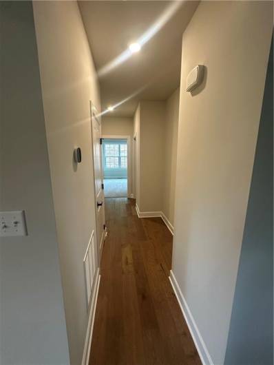 Hall on main level leading to family entry, first floor bedroom and bath
