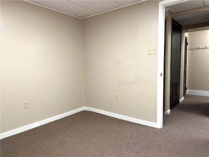 Another View of the Office that Adjoins the Rear office with Wood Wall.