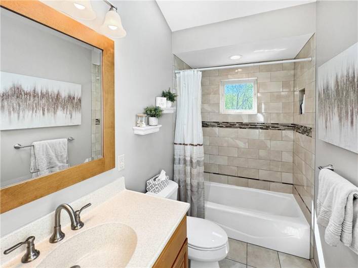 Stunning newer bath with ceramic tile tub enclosure and floor, plus a vaulted ceiling with skylight!