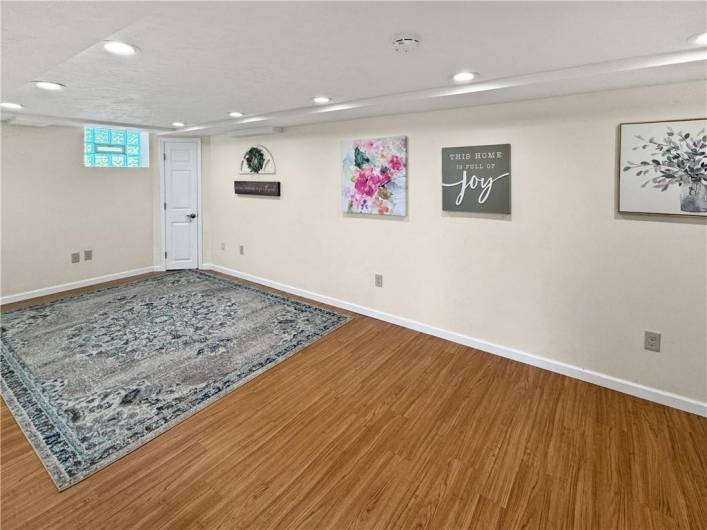 Large newer game room on the lower level with recessed lights.