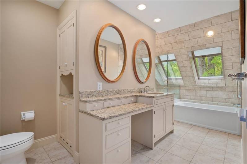 Primary bathroom with glassed in shower and soaking tub.