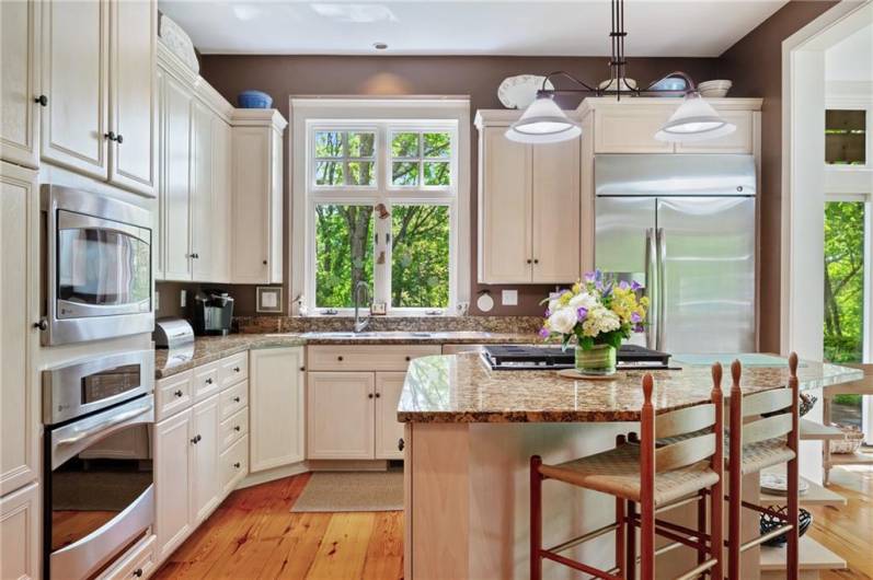 Island with seating and stainless steel appliances.