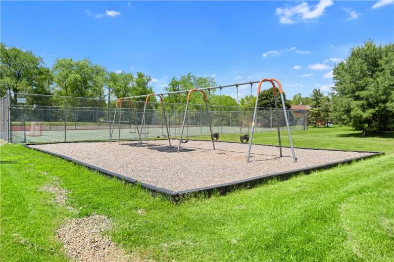 The community swing set adjacent to the sports courts