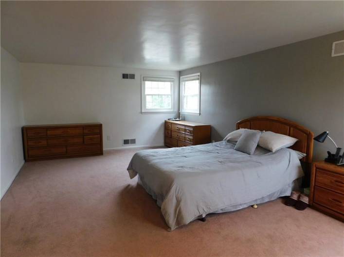 Large Primary Bedroom with corner windows and another single.