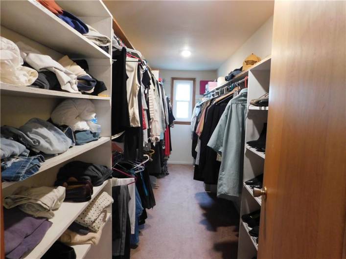 Primary Bedroom with a huge Walkin closet with shelving. Pull down easy access stairway to the attic.