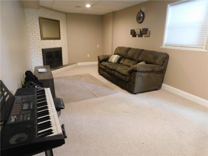 Great Finished Gameroom with Wood burning fireplace.