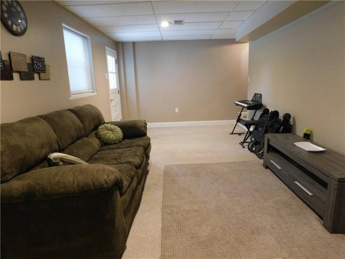 Game Room with a window and door to the back yard.