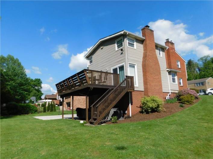 Side view of the home with flowers in bloom and nice landscaping.