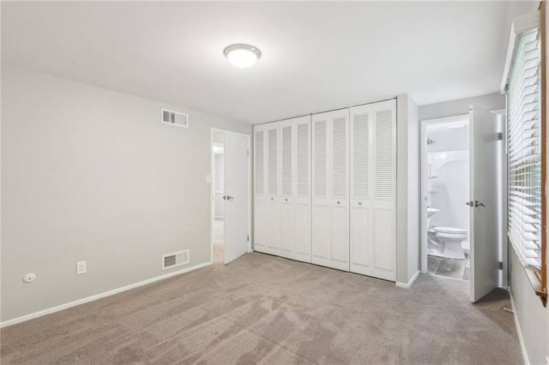 Primary bedroom with view of clean & bright  en suite