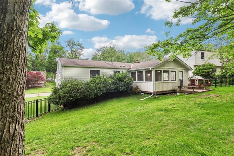 View of huge screened porch & deck with built-in seating.