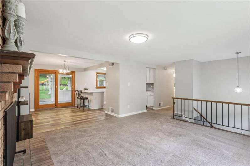 Open Concept, clean and bright with bay window, fireplace & updated black railings