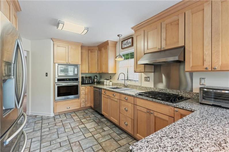 Notice the cabinets go all the way to the ceiling, adding tons of storage space.  Gas cooktop and all stainless steel appliances