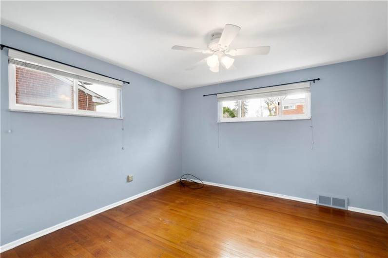 The primary bedroom has two well placed windows that allows for furniture placement without blocking the light.