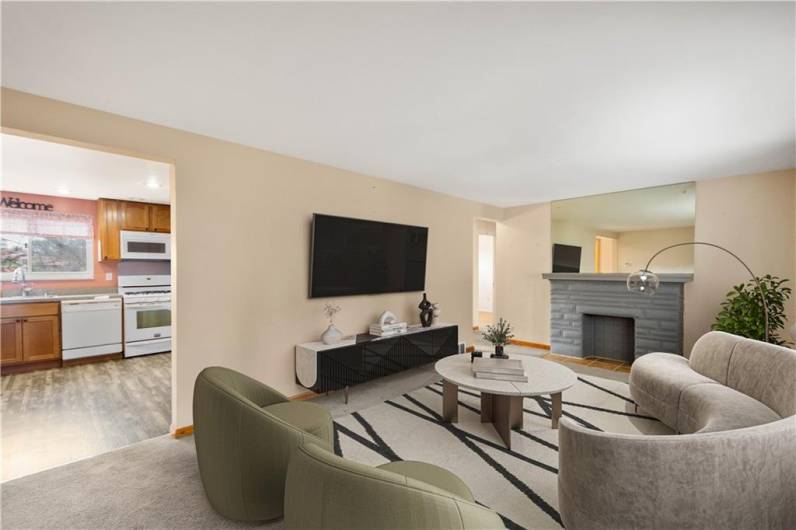 he living room is quite spacious and the decorative fireplace adds to the comfort of the room.