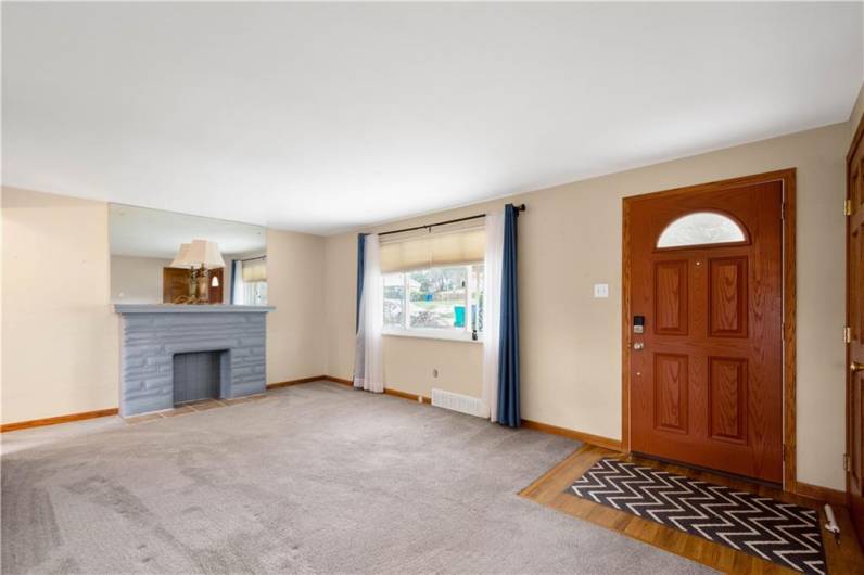 The large picture window allows abundant light into the room. The front door is newer and there is a good area inside the front door to catch any mess from a rainy day.