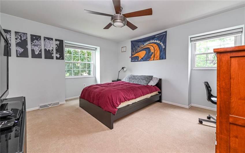 Large second bedroom with ceiling fan and overhead lighting.