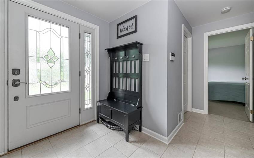 Large entry with insulated steel front door, ceramic tile flooring and coat closet.