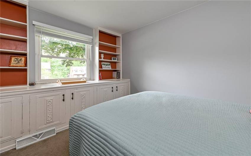 Entry level bedroom with built in book shelf and cabinets.  This room also has a closet.