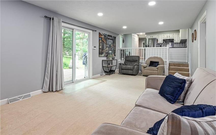 Oversized family room with large sliding door to access level back yard and patio.  Just a few steps up to the kitchen.