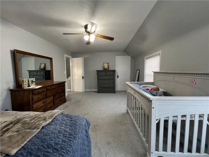 Spacious upper level master bedroom. Hardwood flooring under carpet.