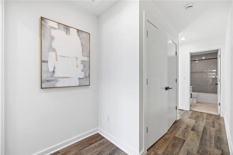 Upper hall way - closet opens to laundry hook ups *Photo of model home at 21 Rose