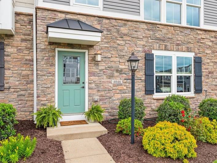 Nestled in the highly desirable Overlook at Southpointe community, this beautifully maintained townhome offers a sophisticated blend of modern style and timeless curb appeal. The exterior showcases a harmonious mix of stone and siding with rich architectural detailing, framed by manicured landscaping and a welcoming walkway.