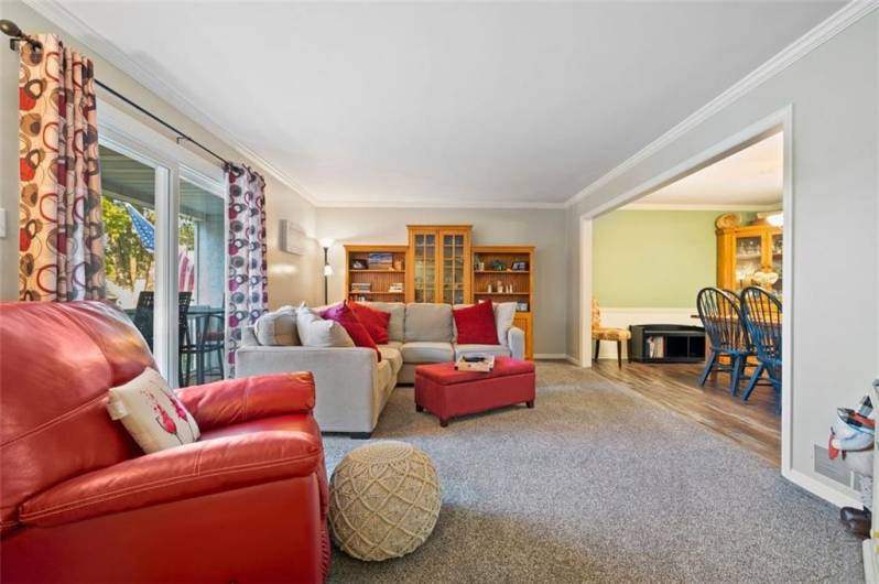 Spacious living room opens to front balcony