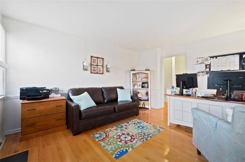Main level bonus room perfect for den, family room, office or shared space