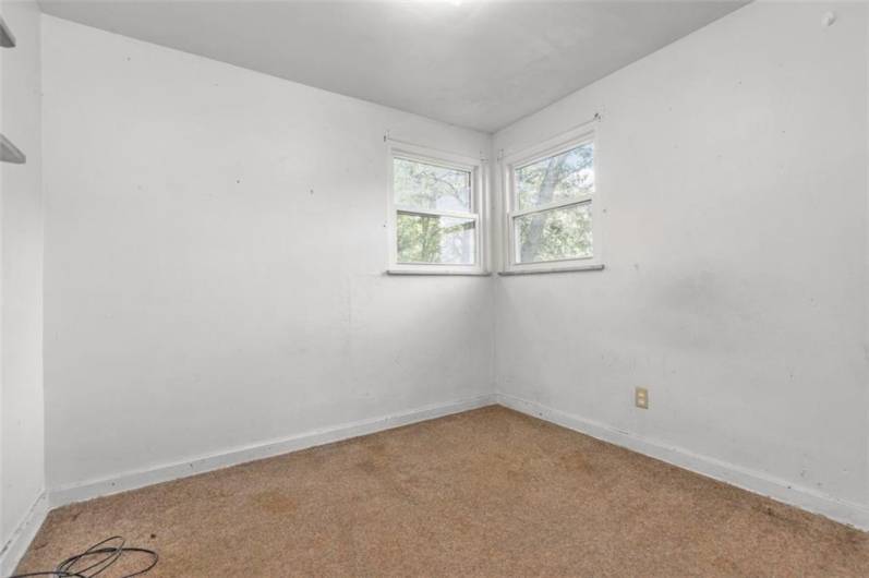 This main floor bedroom (BR 6) could make a great office! Hardwood beneath the carpeting.