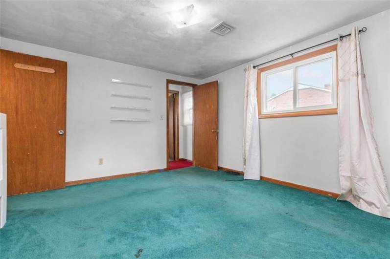 The master bedroom offers a walk-in closet and overhead lighting.
