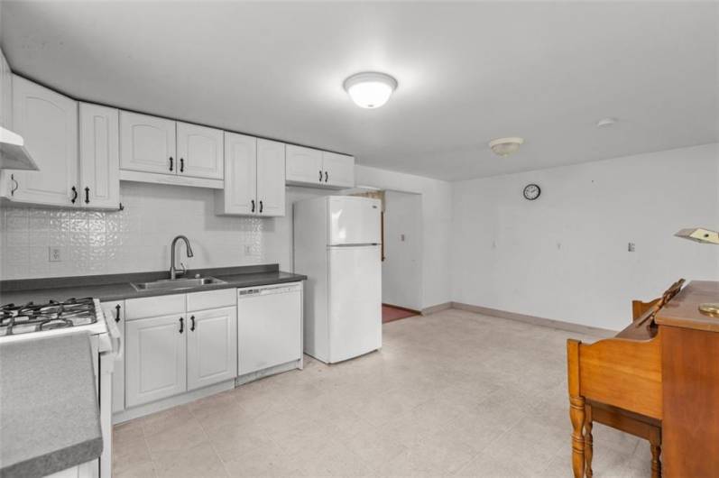 SPACIOUS white kitchen is cheerfully bright! Gas stove, refrigerator and dishwasher are AS IS.