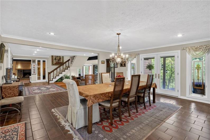 Dining room with French doors to deck and stairs to Upper Level in background