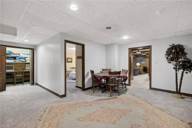 Lower level sitting area showing work space to the left, bedroom behind and Gameroom to the right