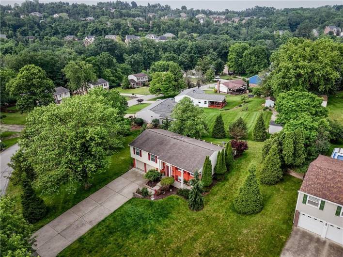 Home sits back from the street showcasing the large lot!