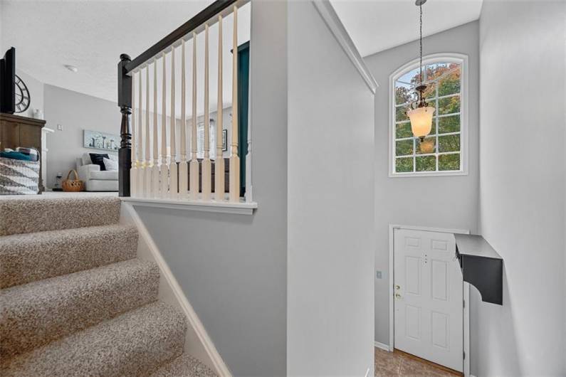 The grand 2 story entrance opens to the family room above.