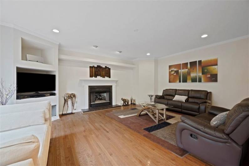 Experience unparalleled comfort and elegance in this grand family room, centered around a welcoming fireplace that invites relaxation