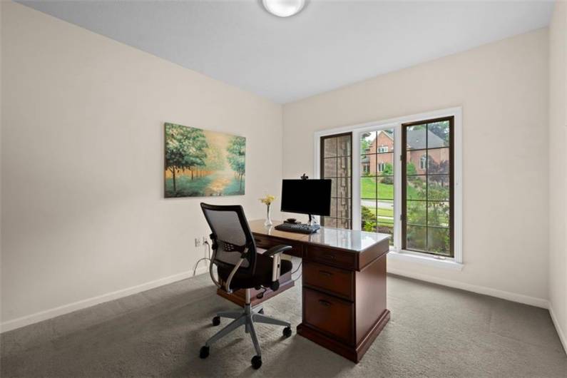 A sophisticated main-level den—perfect for focused work or quiet retreat