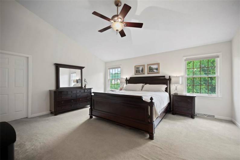 A stunning owner’s suite with vaulted ceilings—where space and serenity beautifully converge