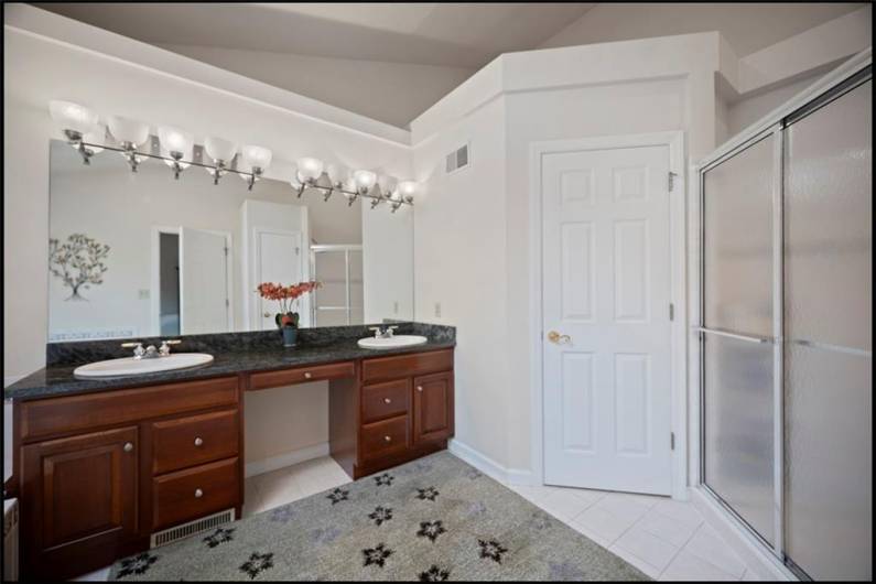 Experience ultimate luxury in the owner’s bath, featuring dual sinks, elegant vanities, a spacious shower, and a tranquil spa bath