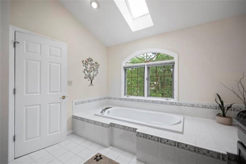 Indulge in a radiant spa bath illuminated by a skylight, transforming daily routines into moments of blissful tranquility