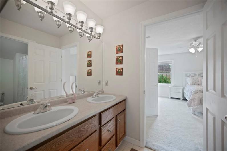Seamless shared luxury—this Jack & Jill bath blends privacy with thoughtful design