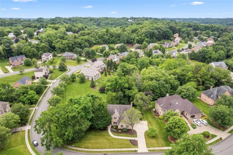 A stunning aerial perspective showcasing this exquisite residence nestled in the prestigious Bennington Woods enclave
