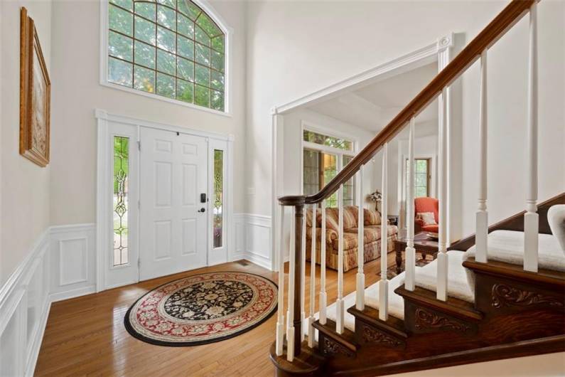Two-story grand entrance with soaring Palladian windows