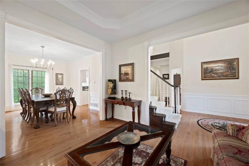 Seamless transition between living and dining areas highlighted by rich, gleaming hardwood floors