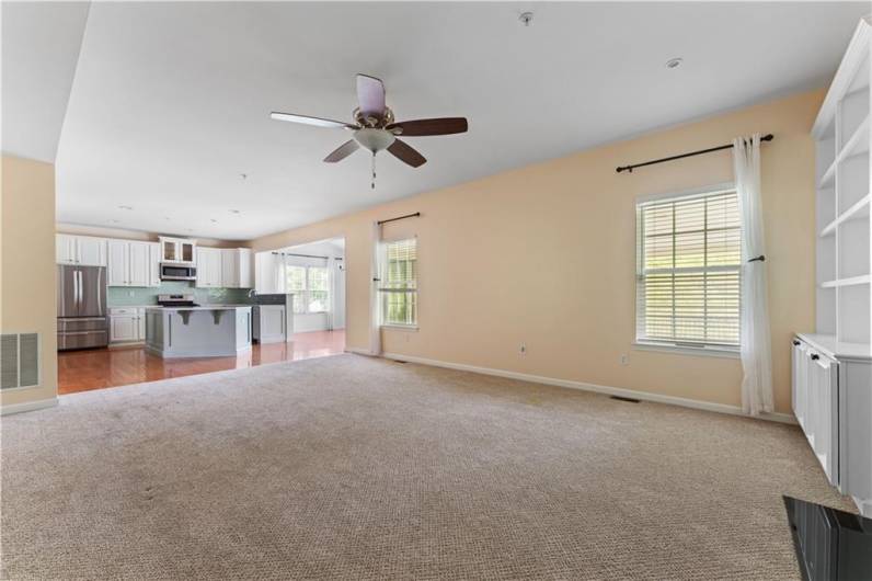multiple windows and fan in family room. Lots of options for your furniture.