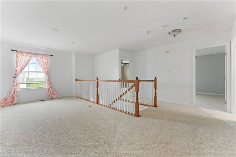 Loft with window overlooking front yard.