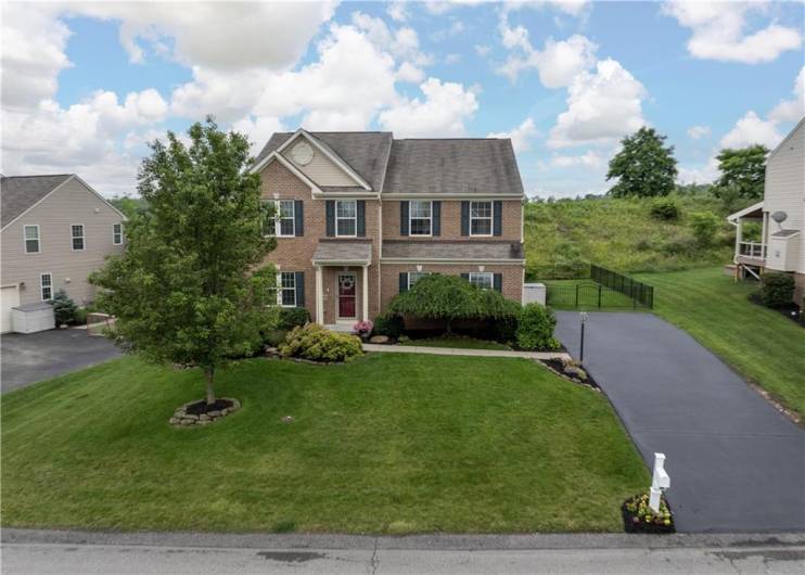 Brick front elevation and freshly landscaped.