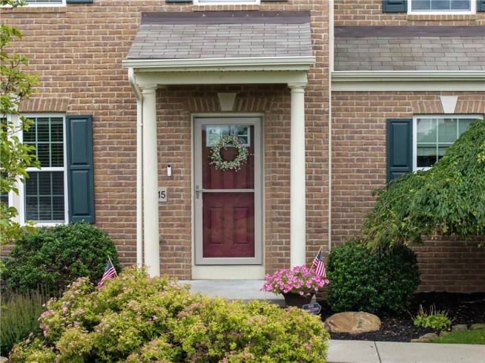 Brick exterior, glass storm door.